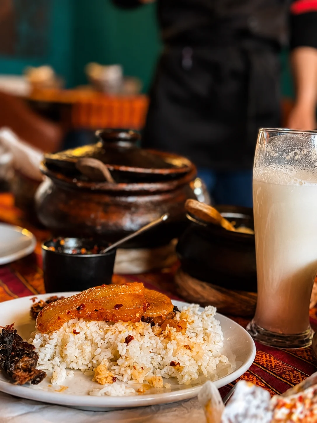 Rice meal served with Bhutanese side dishes and a chilled drink