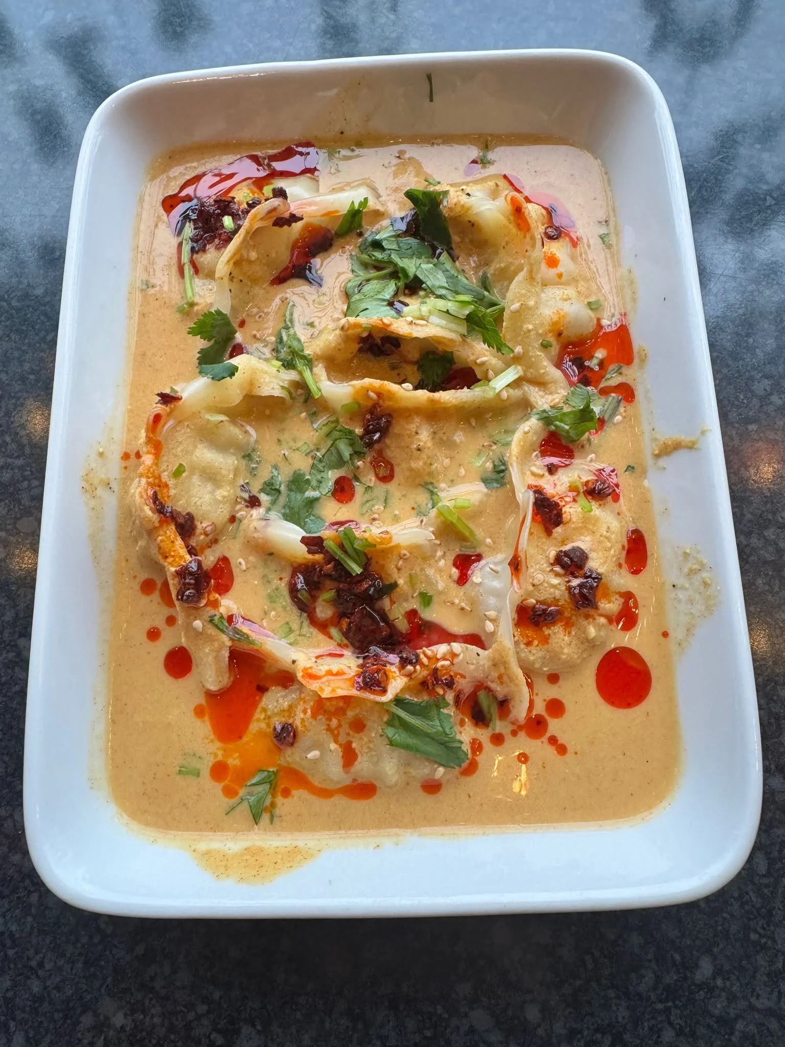 Momo dumplings served in a rich sauce at Hima-Fuji